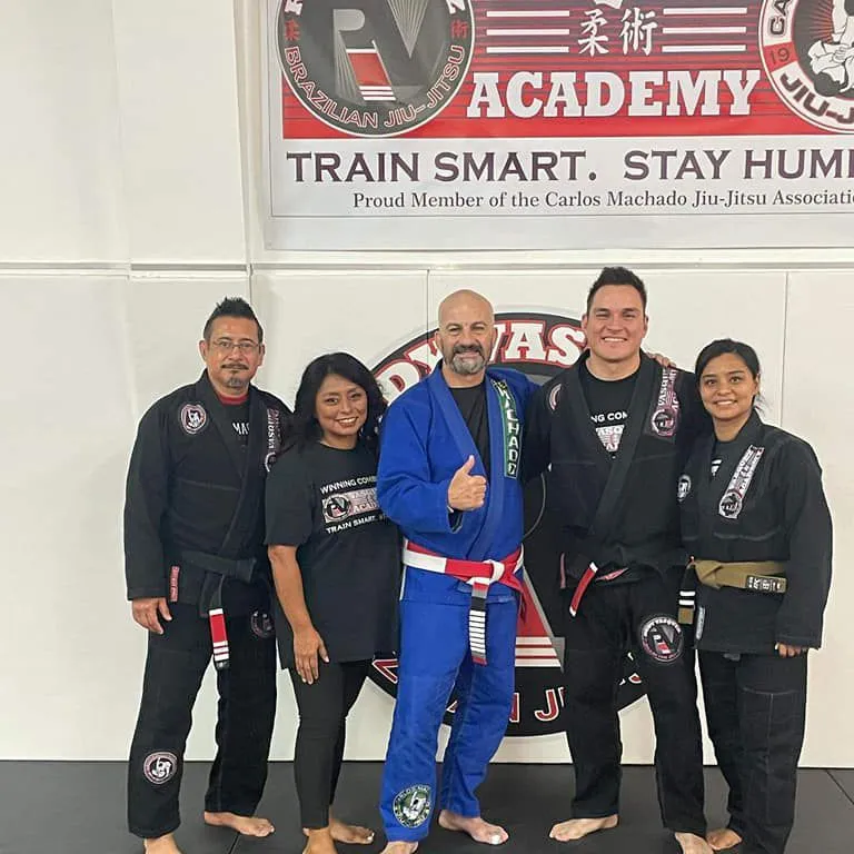 Rudy Vasquez poses with Carlos Machado and Family.